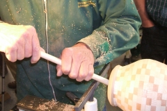 Dave Line sanding the inside of his laminated vessel, with the use of some sanding cloth attached to a push stick.
