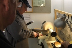 Bill Munro repositioning the tool rest as he comes up the side of his bowl.