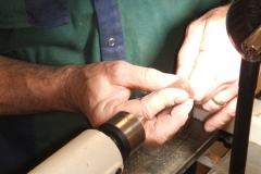 Here David is sanding the tip with the lathe running being supported by his left hand.