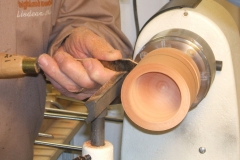 Here Uisdean is making a shallow cut with the parting tool where the box extends to and the cut off point will be.