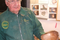 John was finished first, he he is showing his finished bowl to the members watching.