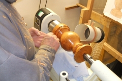 Bill Munro sealing his lamp base, flattening the sealer prior to polishing.