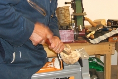 Here Mark can be seen paring out the inside of the cup of the spoon, he is using a normal gouge and a carving bench that he can sit on as he works.