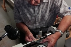 One of his first pen barrels being hand sanded.