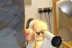 This is Bill Munro working a very wet log that he split in half to make a natural edged bowl.